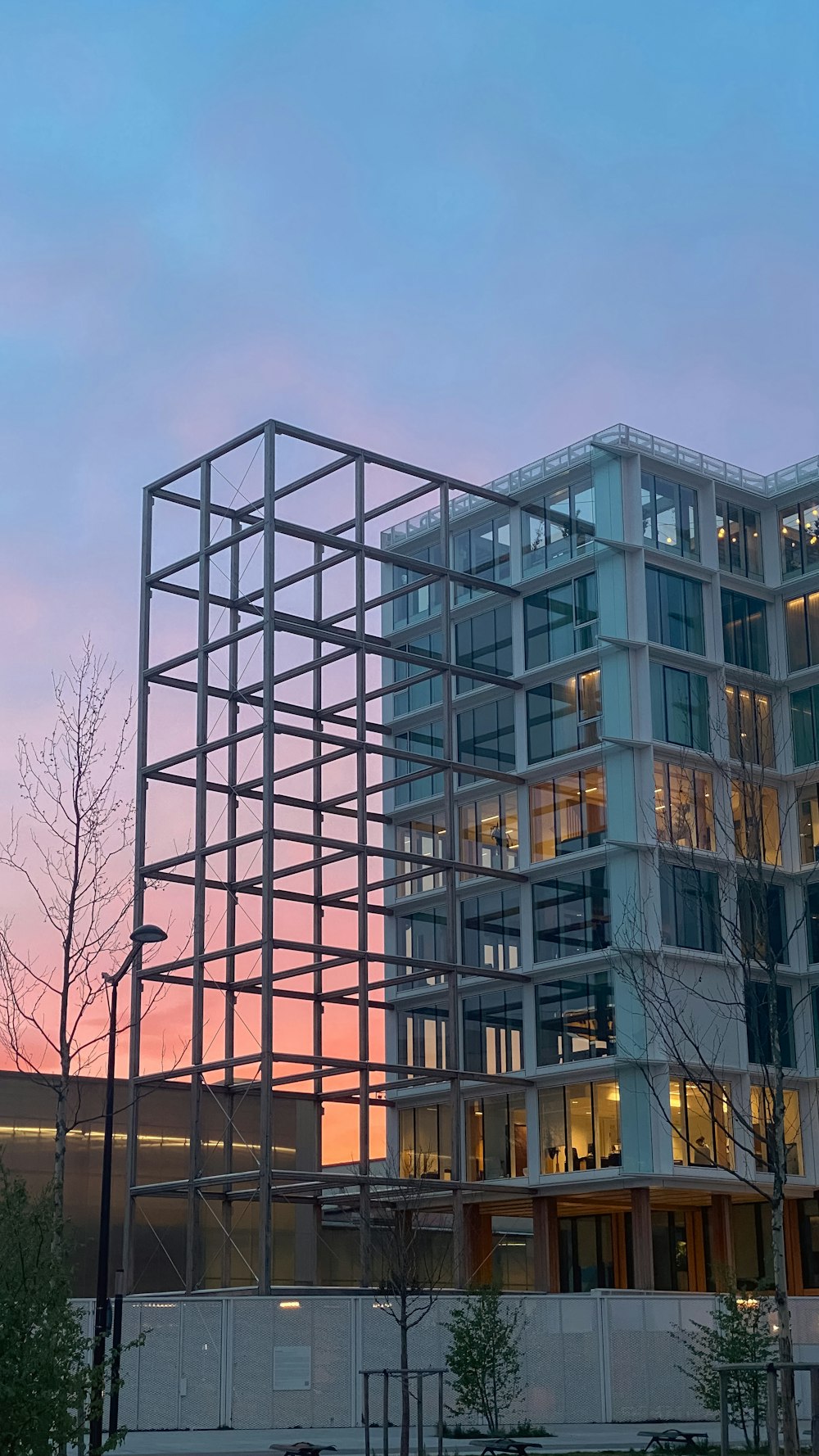 a tall building with a lot of windows next to a street