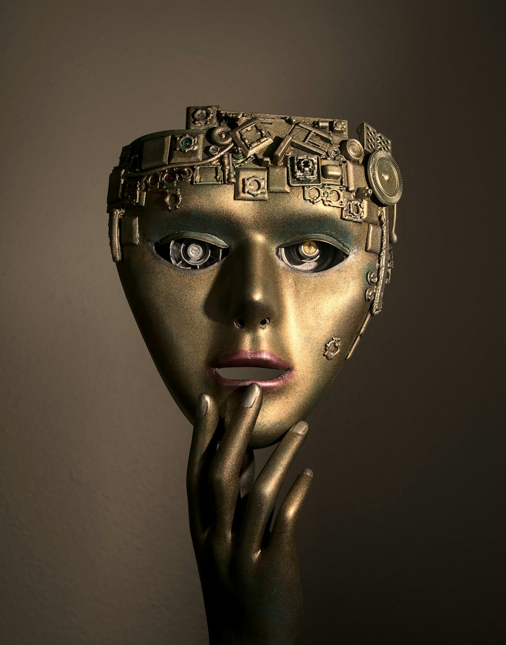a woman's face with a gold mask on her head