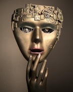 a woman's face with a gold mask on her head