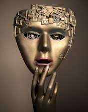 a woman's face with a gold mask on her head