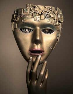 a woman's face with a gold mask on her head