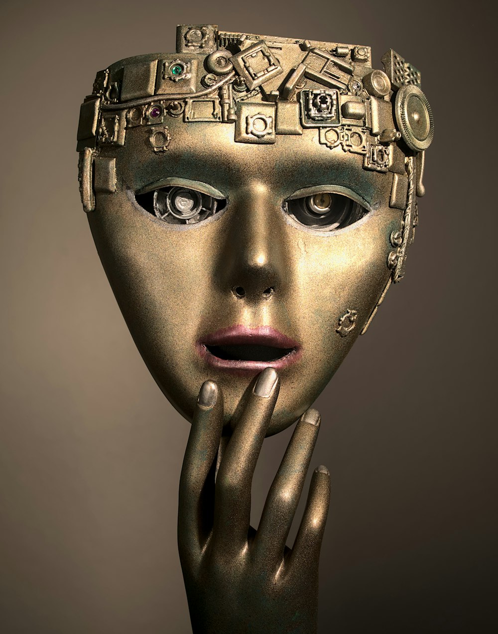 a woman's face with a gold mask on her head