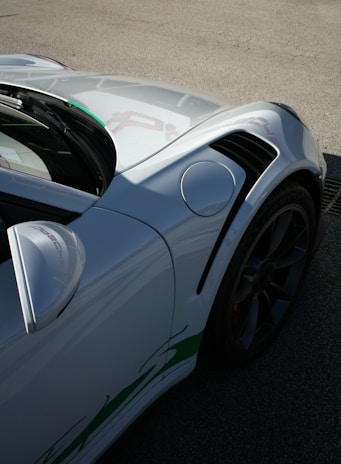 a white sports car parked on the side of the road