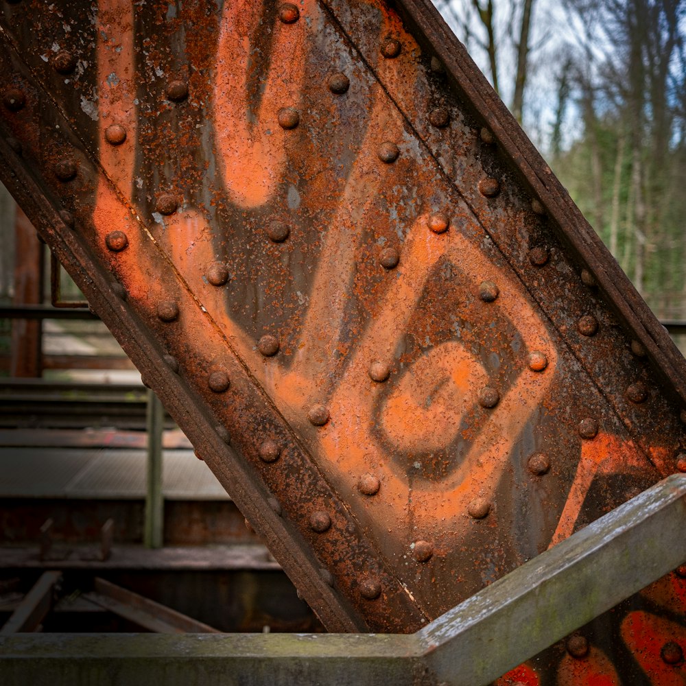 an old rusted metal bridge with graffiti on it