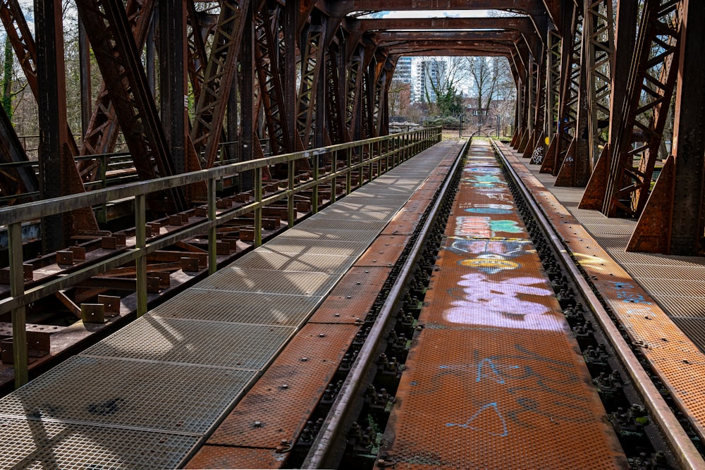 a train track with graffiti on the side of it