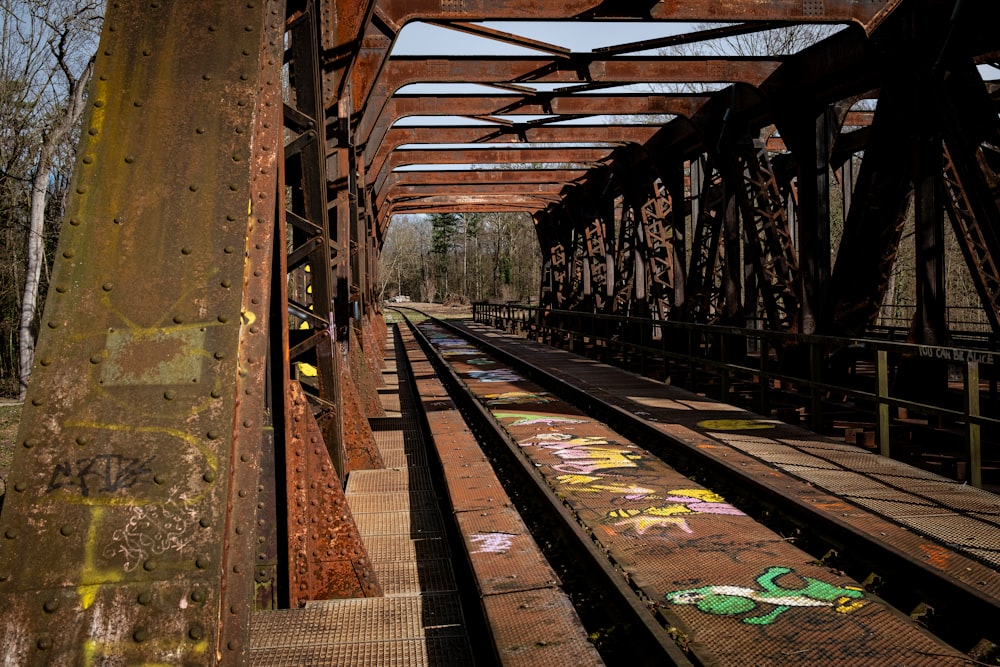 a train track with graffiti on the side of it
