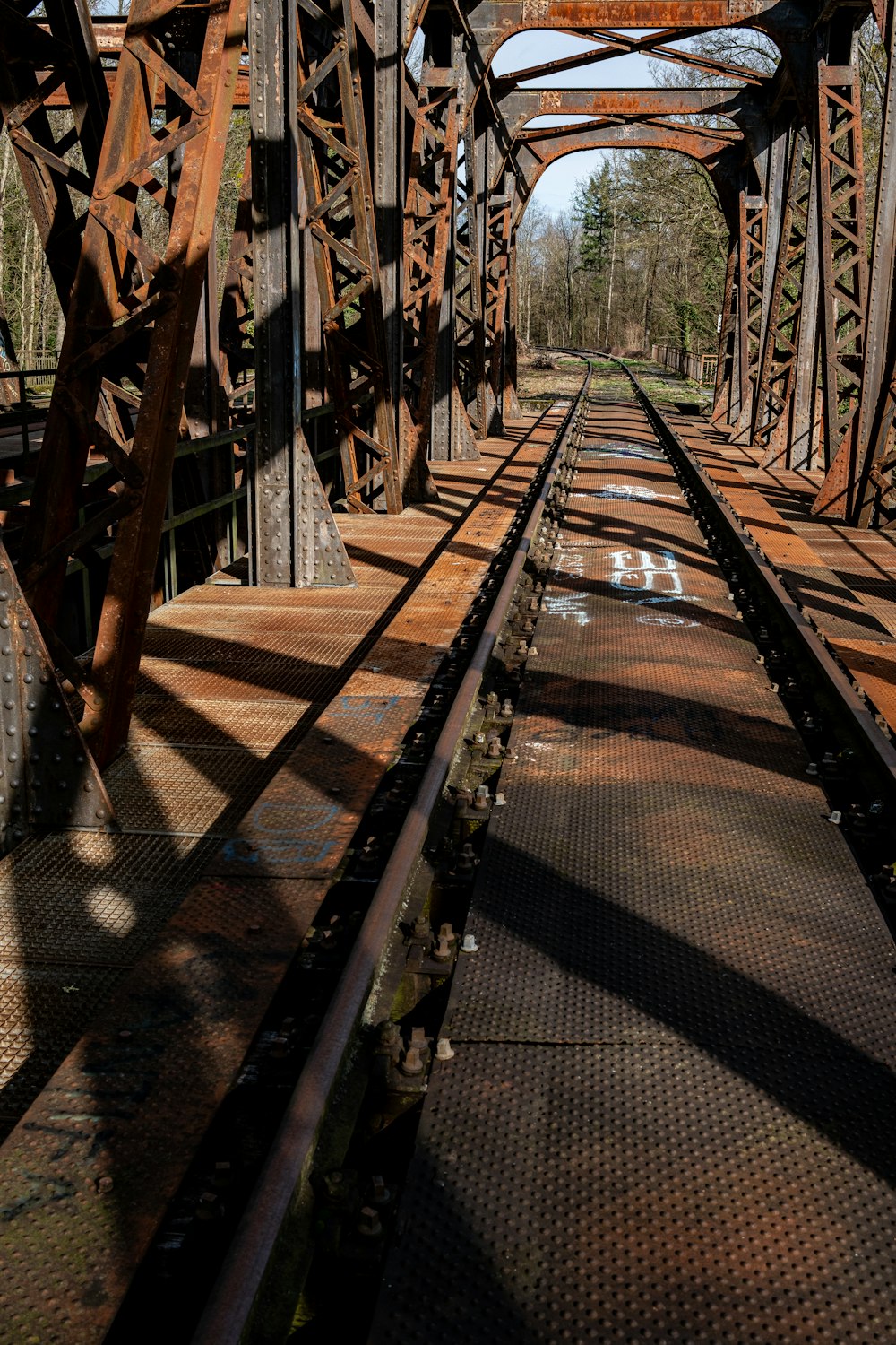 a train track going across a bridge over water