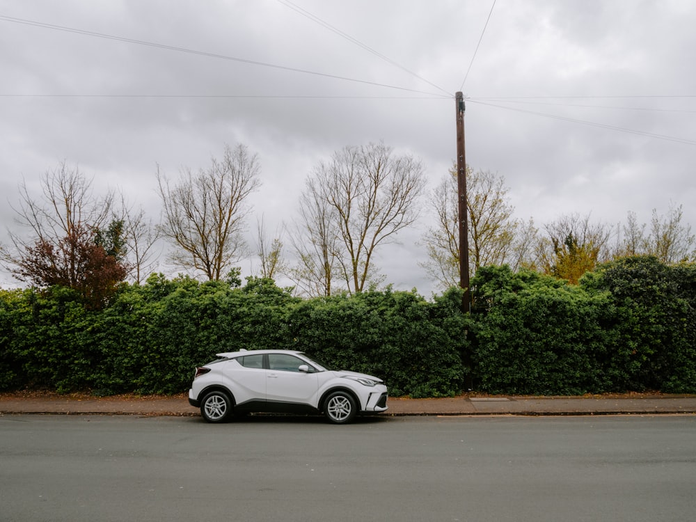 a white car parked on the side of the road