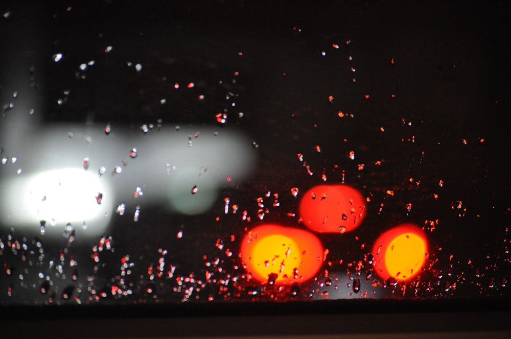 rain drops on the windshield of a car at night