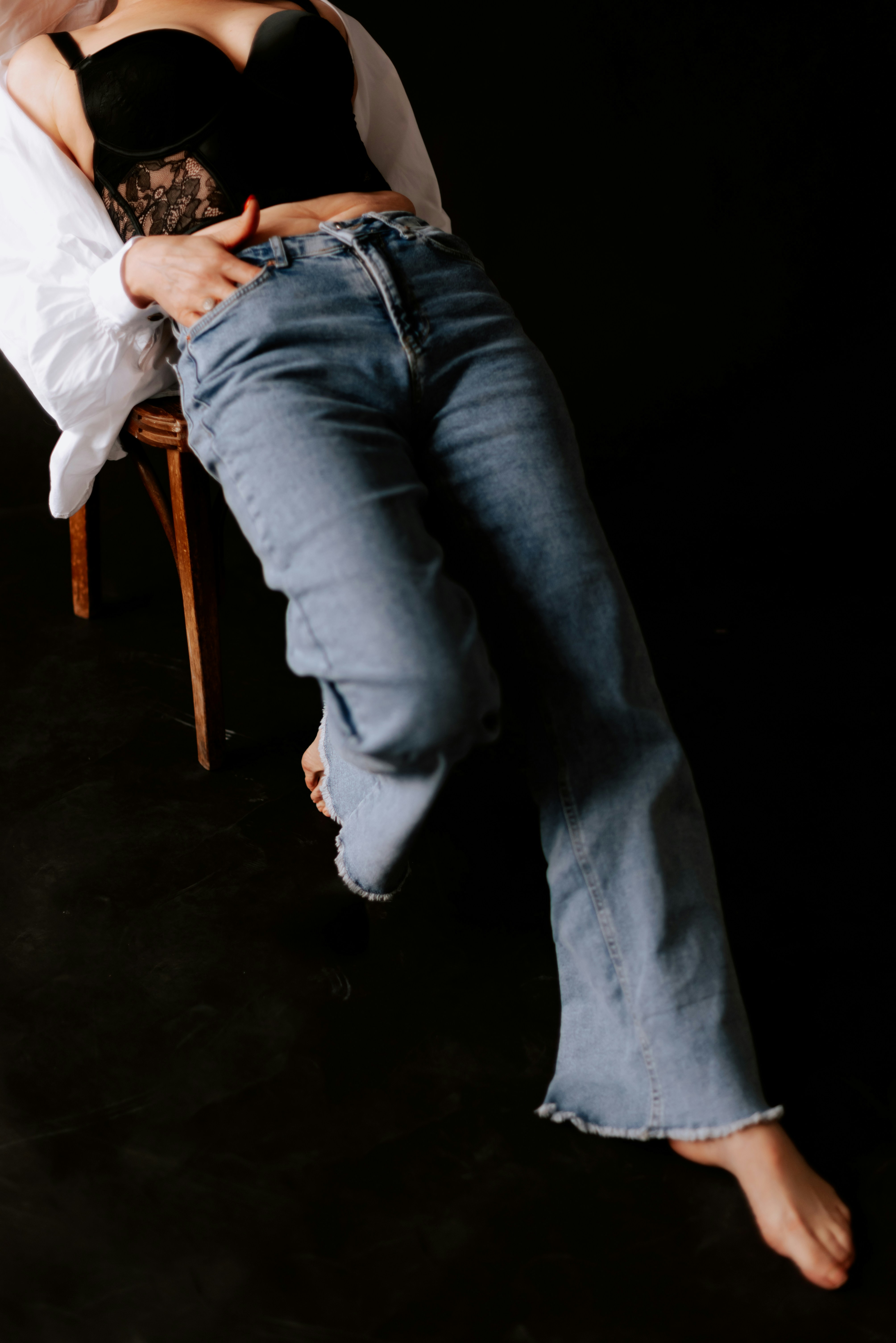 a woman sitting in a chair with her legs crossed