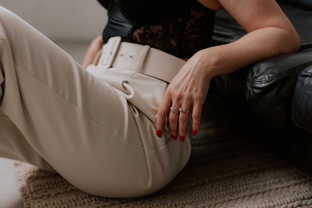 a woman sitting on a couch with her legs crossed