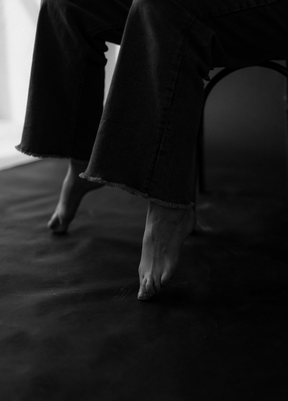 a black and white photo of a person's bare feet