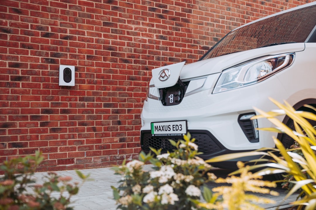 a white car parked in front of a brick wall, EV Charging for vans at the comfort of your own home with Zaptec