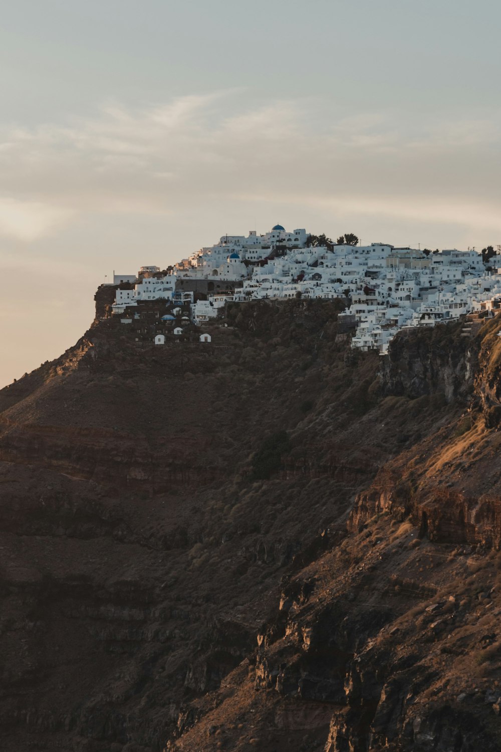 a hill with a bunch of white buildings on top of it