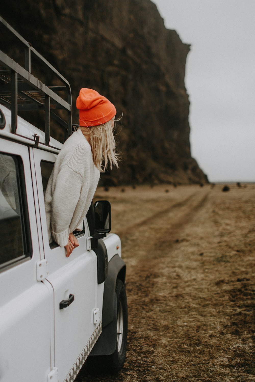 a woman standing on the back of a white truck