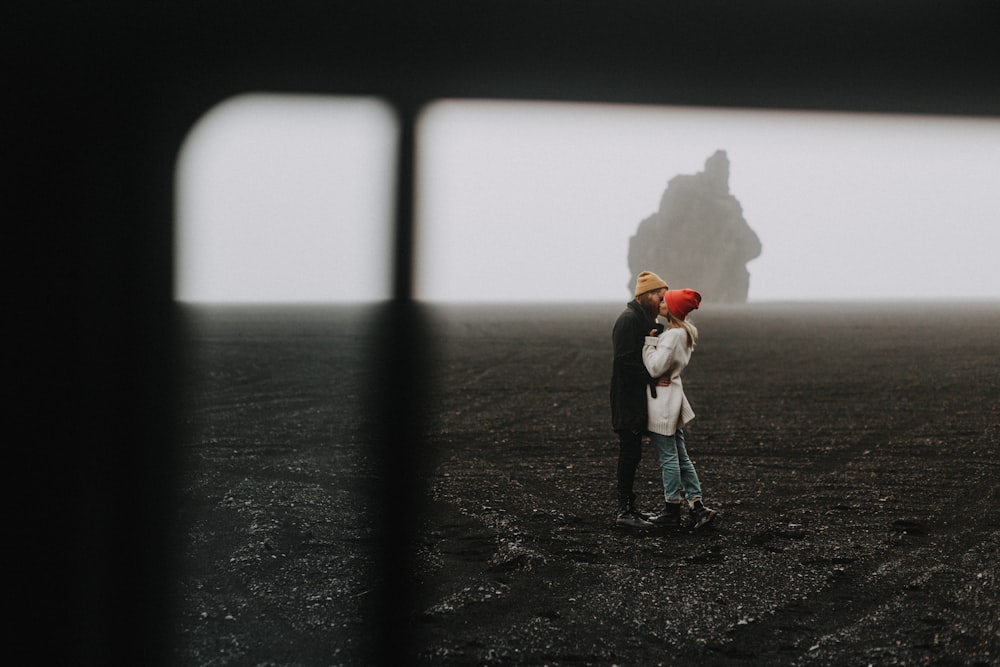 a man and a woman standing in a field