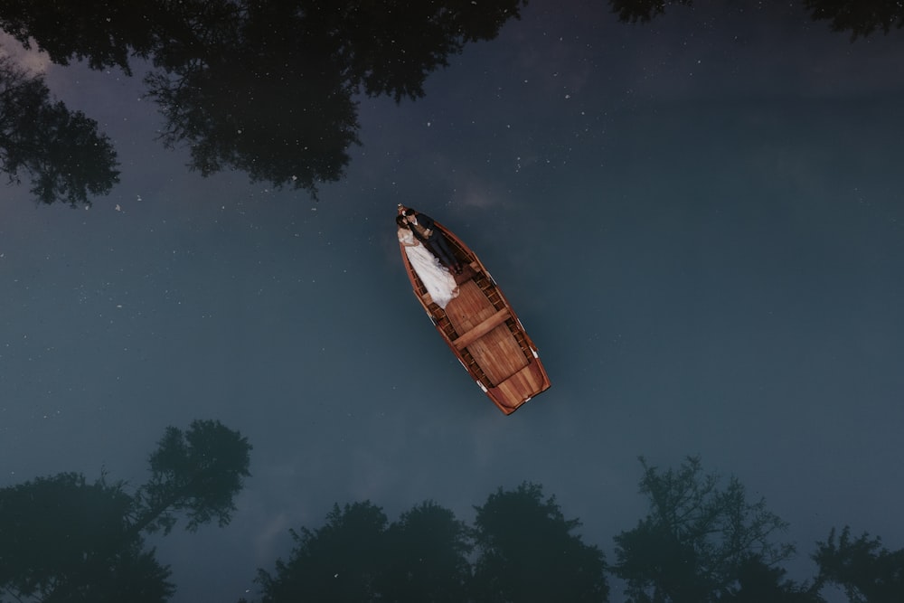 a small boat floating on top of a body of water