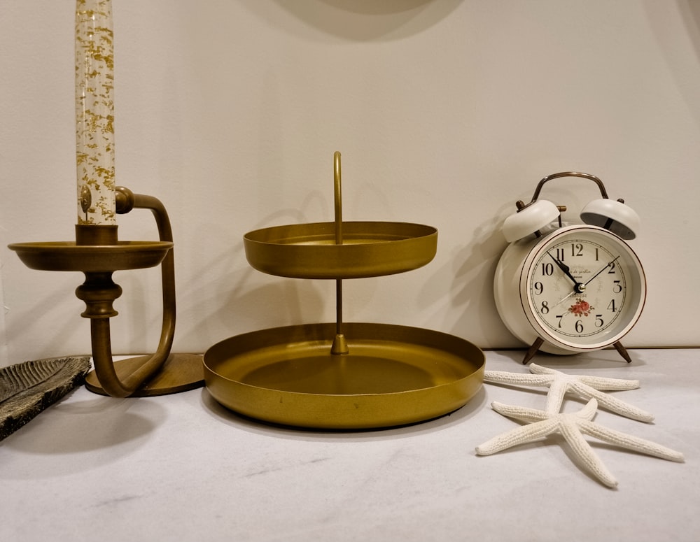 a table with a clock, candle, and other items on it