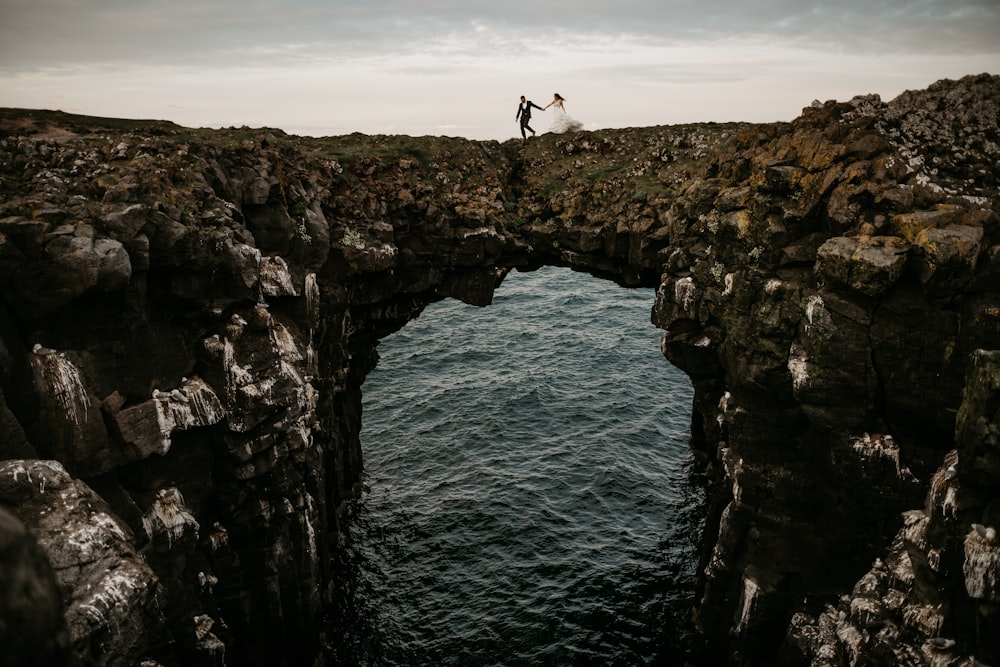 a couple of people that are standing on a bridge