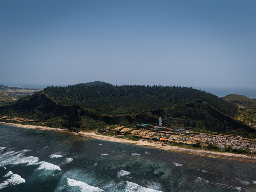 an aerial view of an island with a lighthouse on top of it