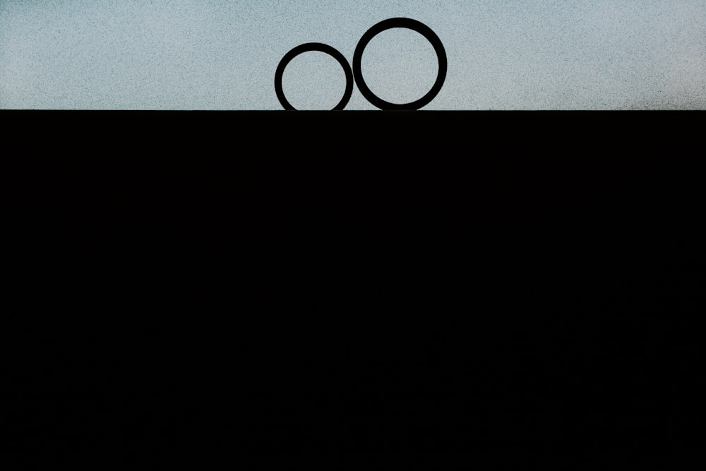 a couple of rings sitting on top of a hill