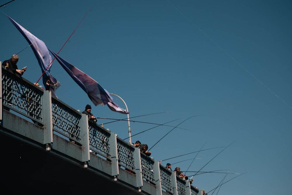 a group of people standing on top of a bridge