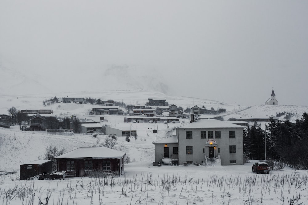 a snow covered hill with houses on it