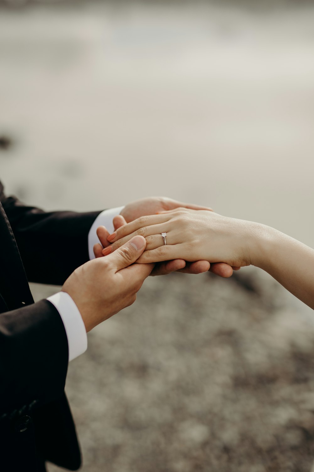 a close up of two people holding hands