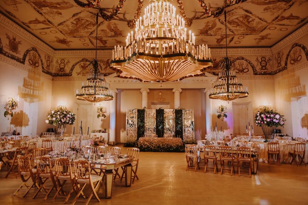 a banquet hall with chandeliers and tables