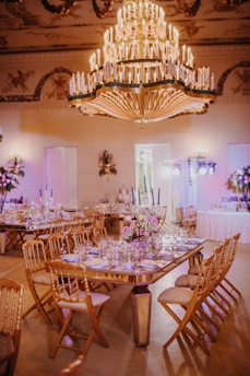 a dining room with a chandelier and tables