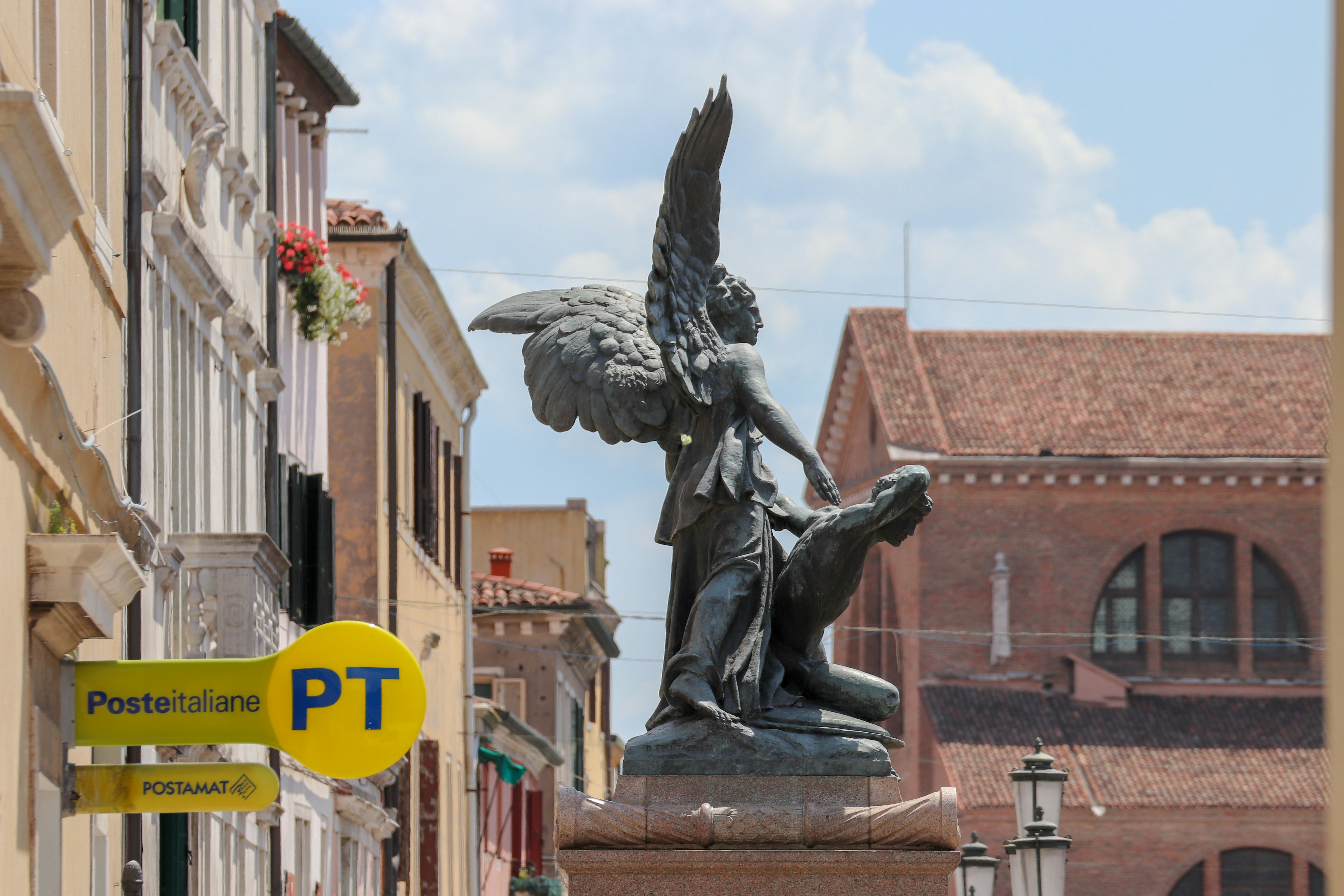 a statue of an angel holding a child
