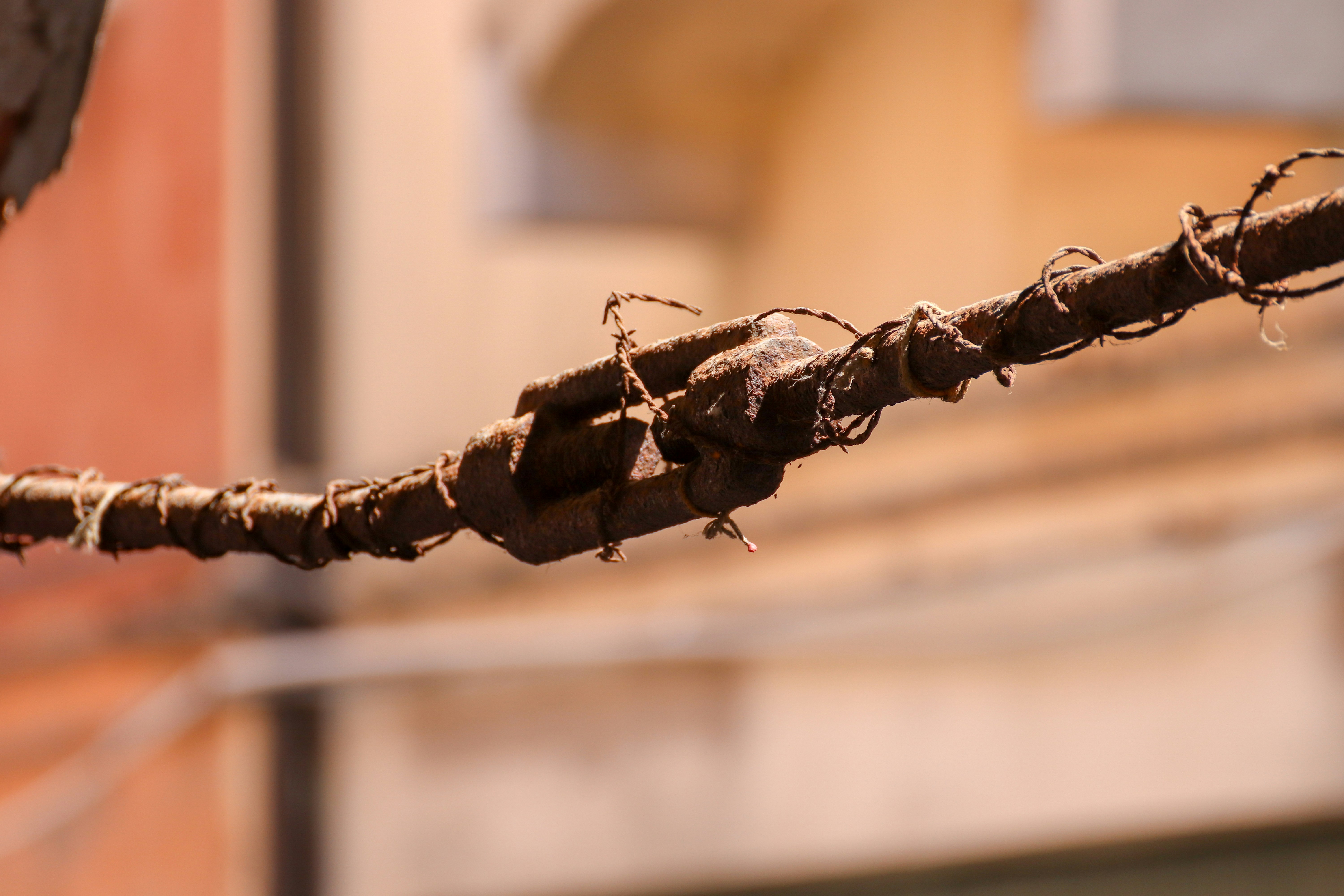 Close-up of a frayed electrical cord with exposed copper wiring - electrical safety tips every homeowner should know