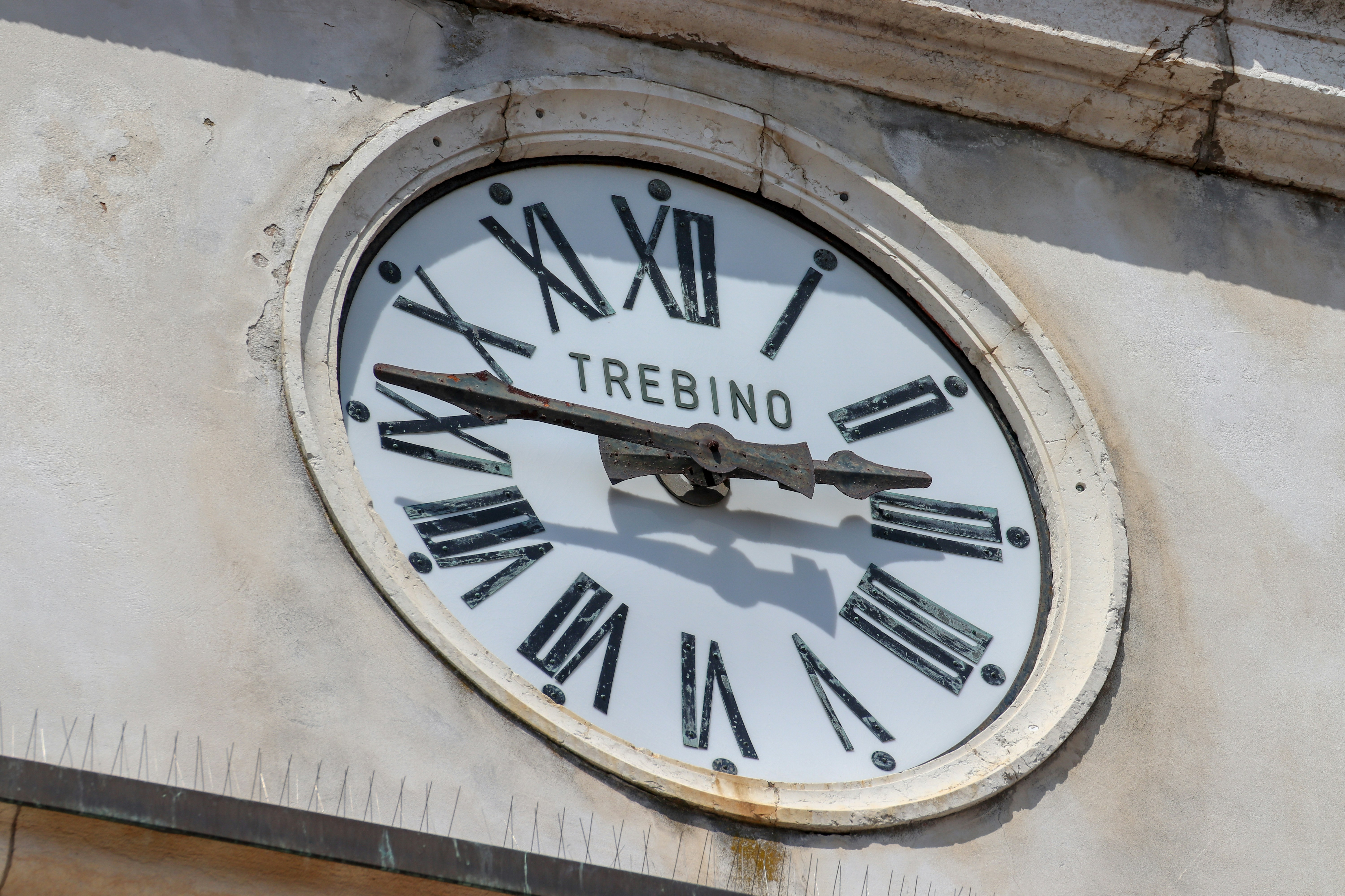 a clock on the side of a building with roman numerals