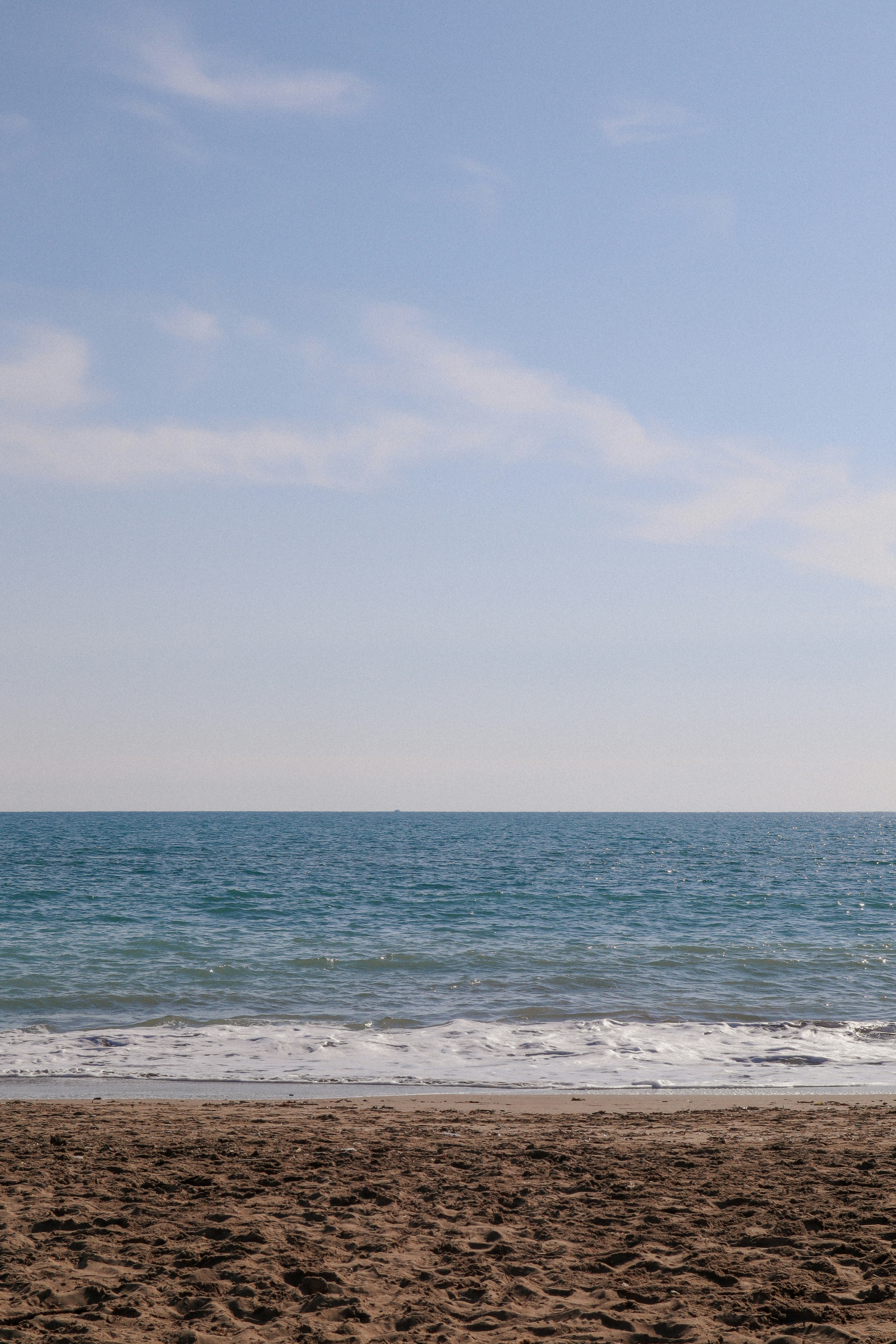 a person on a beach with a surfboard