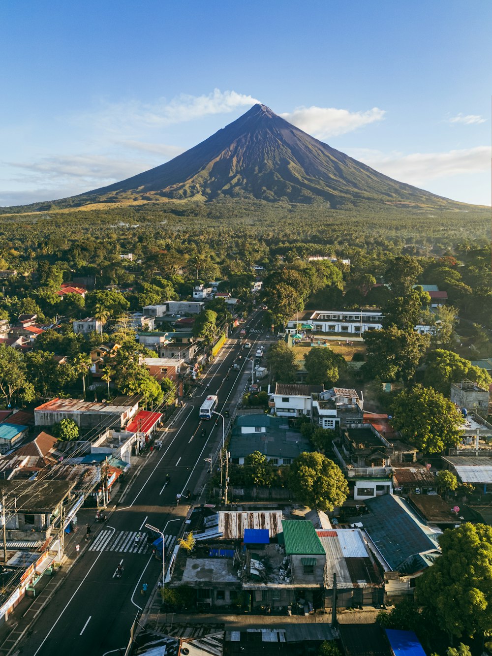 an aerial view of a city with a mountain in the background