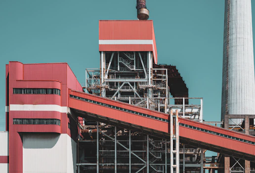 a factory building with a large pipe sticking out of it's side