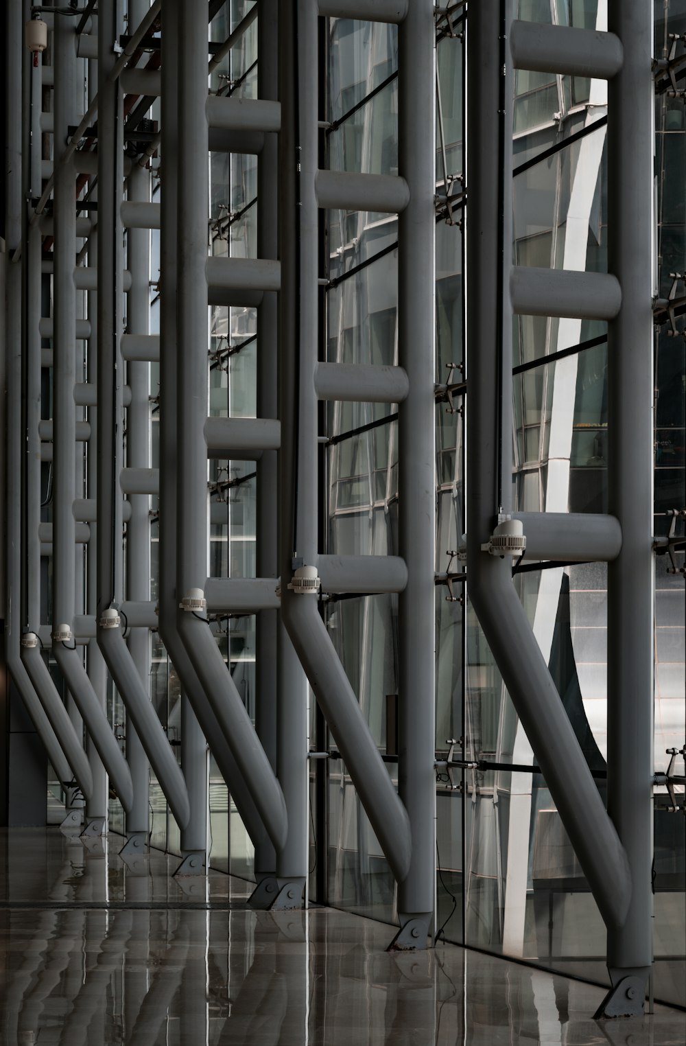 a row of metal pipes in front of a building