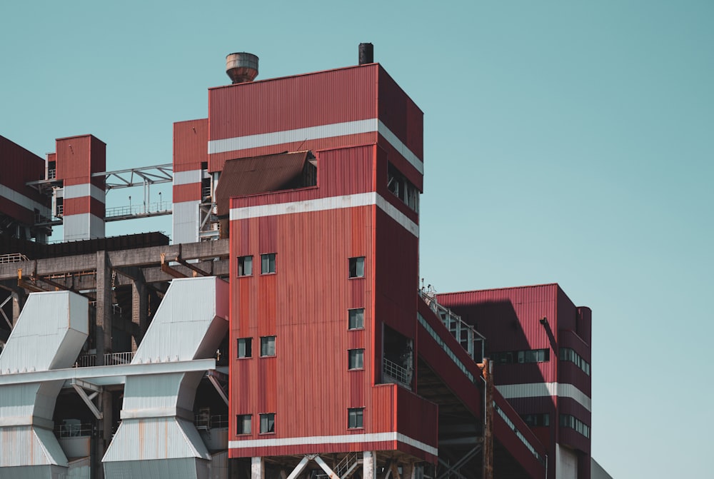 a tall red building with a sky background