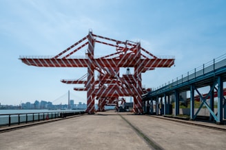 a large metal structure sitting next to a body of water