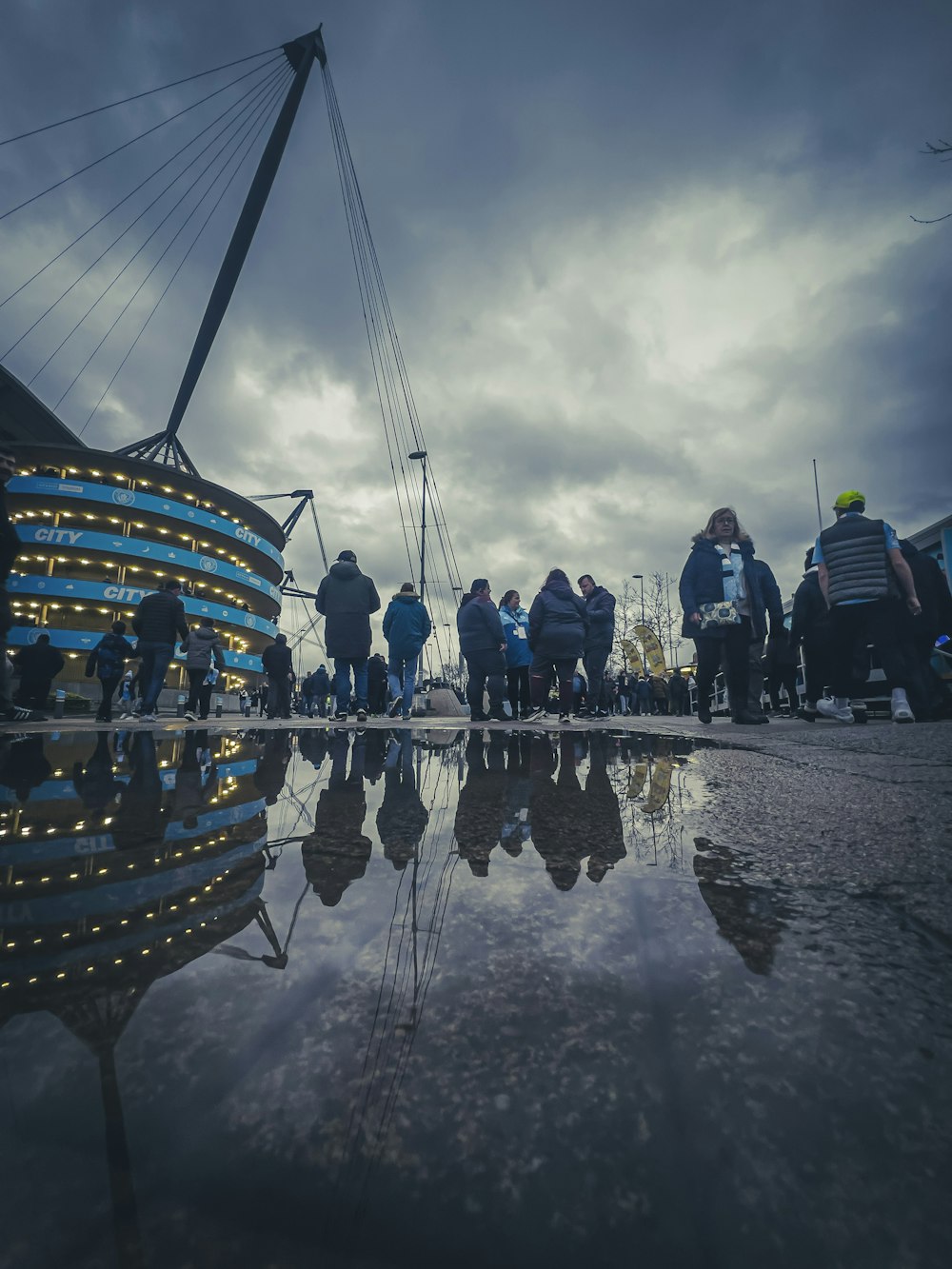 a group of people standing next to each other near a body of water