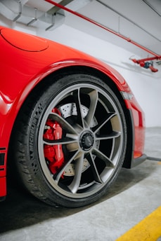 a red sports car parked in a garage