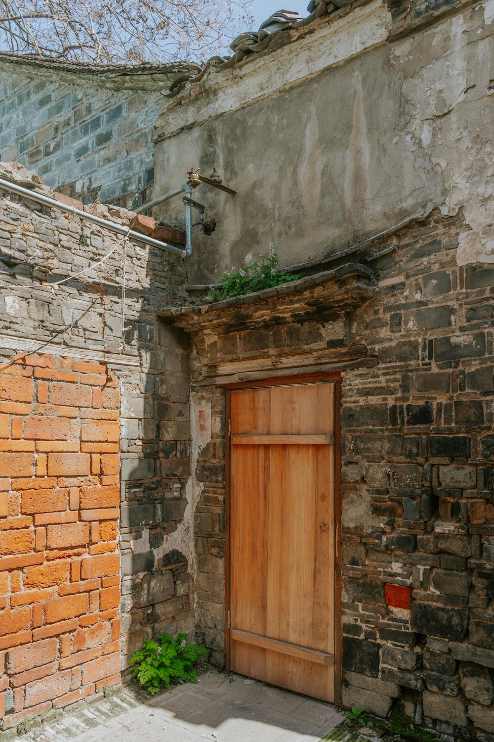 an old brick building with a wooden door