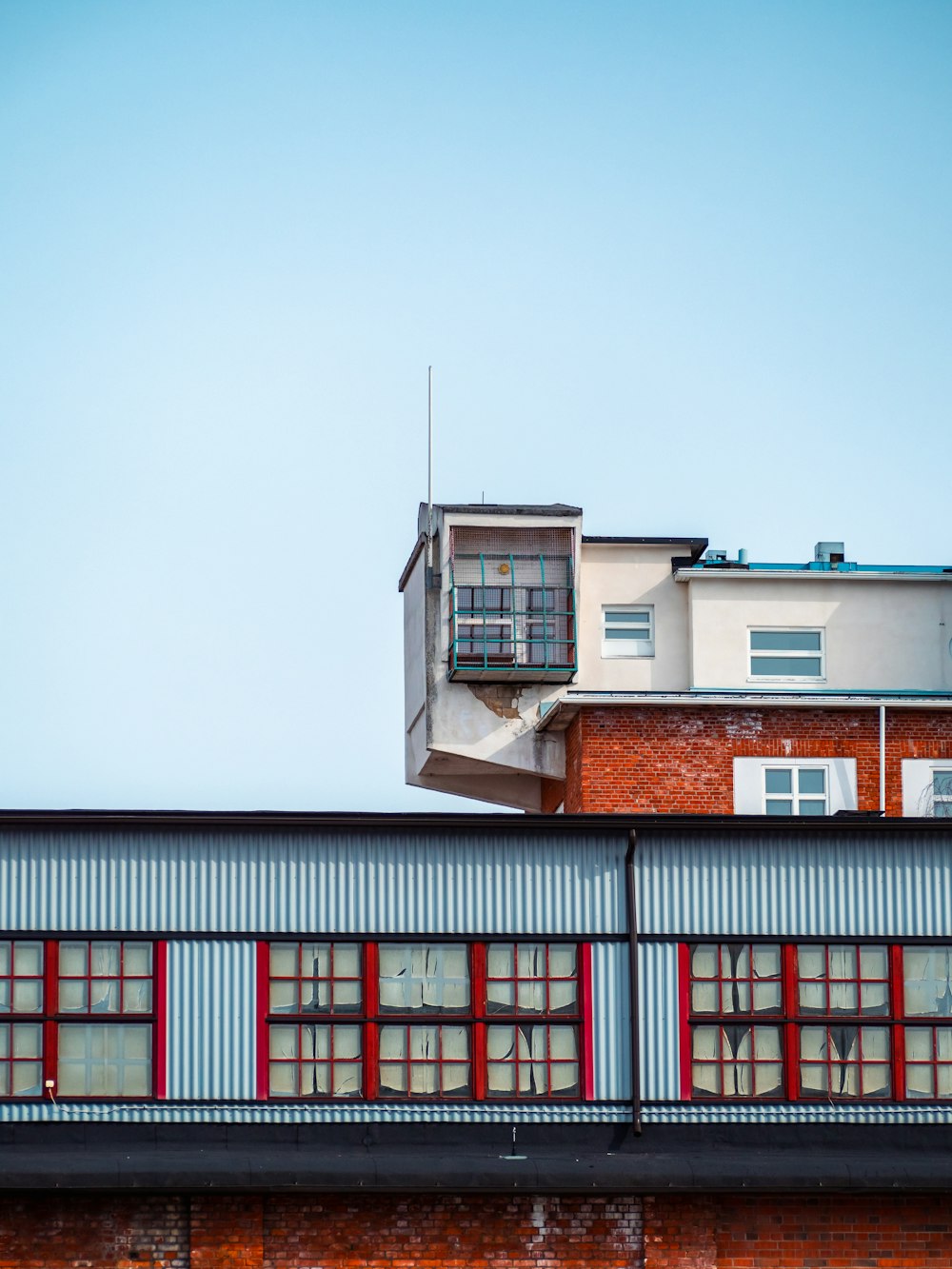 a red brick building with windows and a balcony