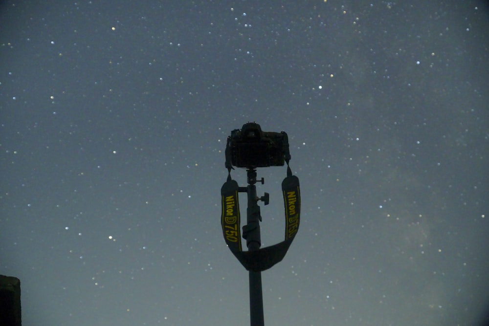 a street light with a sky full of stars in the background