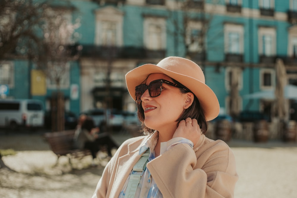 a woman wearing a tan hat and sunglasses