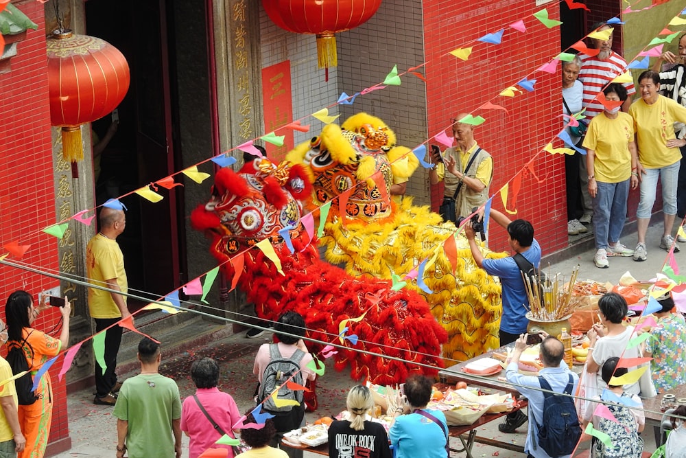 a group of people standing around a dragon float