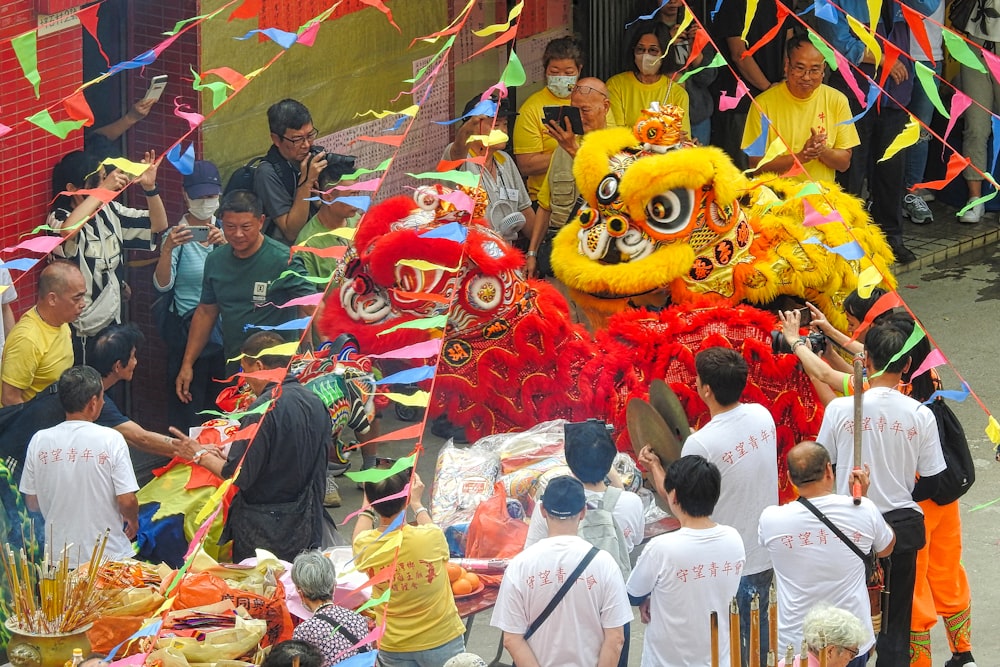 a group of people standing around a dragon float