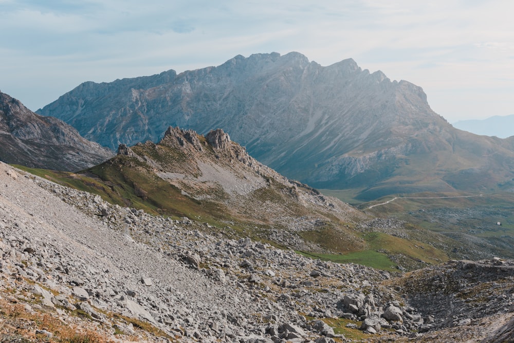 a view of a mountain range from the top of a hill