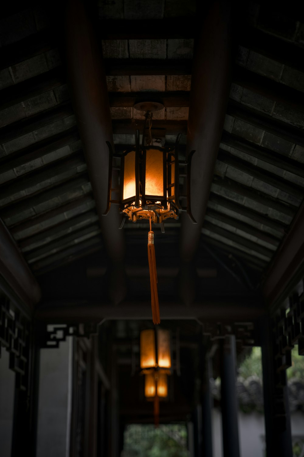 a lantern hanging from the ceiling of a building