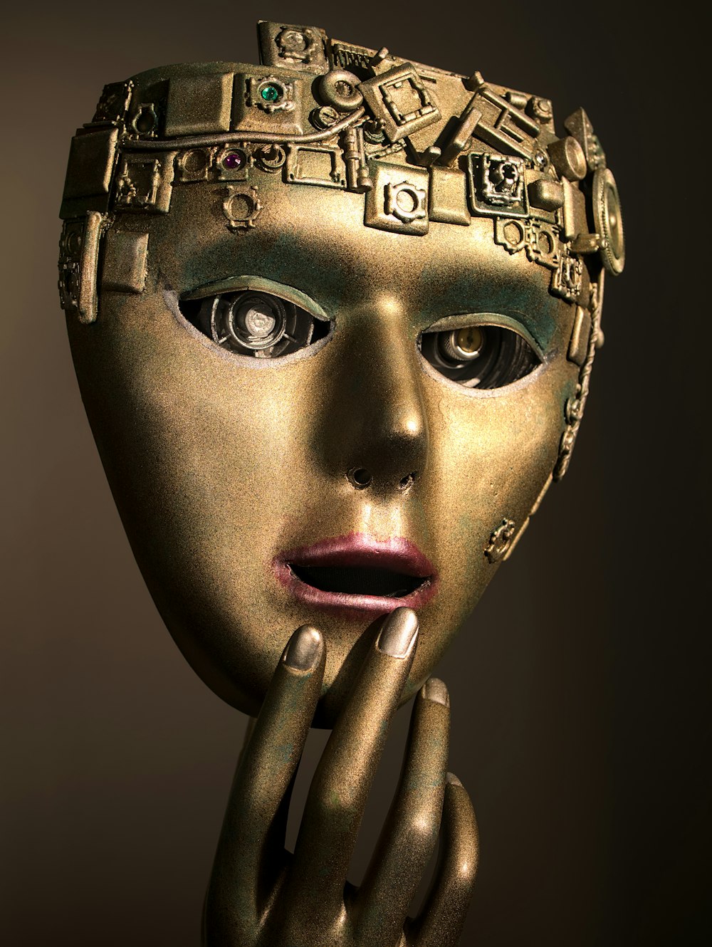 a woman's face with a gold mask on her head